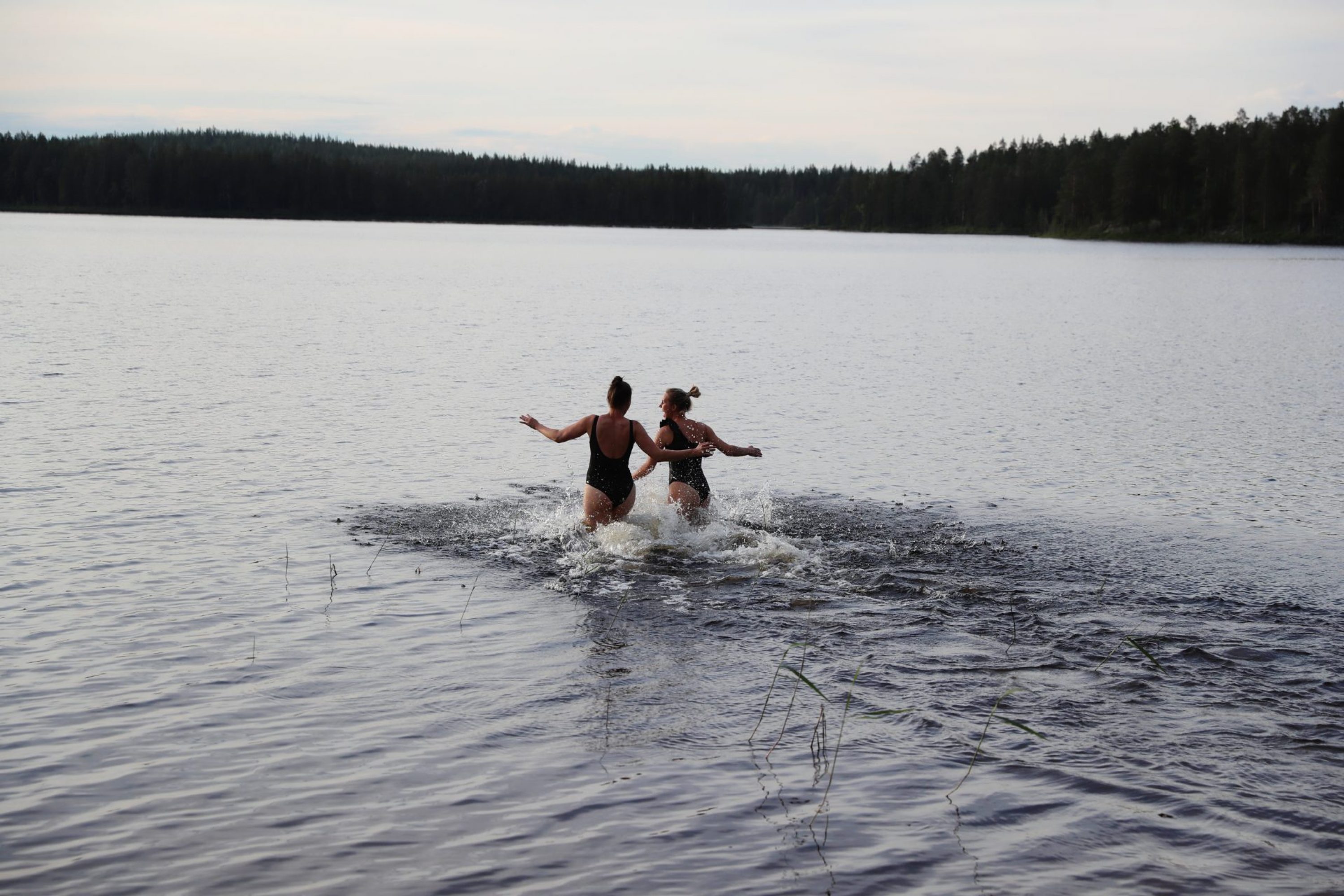 Two women running to the lake